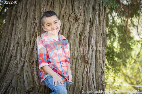 Image of Mixed Race Young Boy Standing Outdoors.