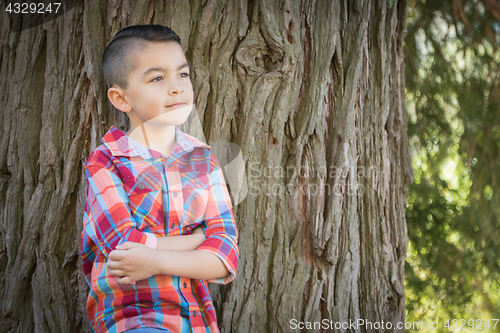 Image of Mixed Race Young Boy Standing Outdoors.