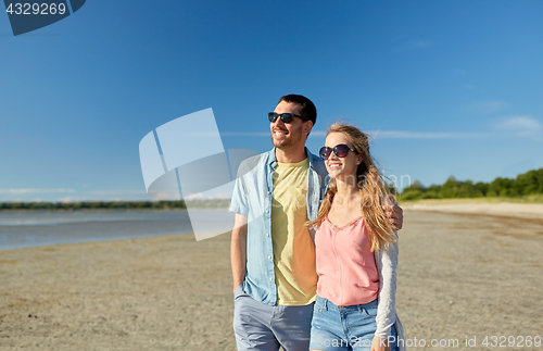 Image of happy couple hugging on summer beach