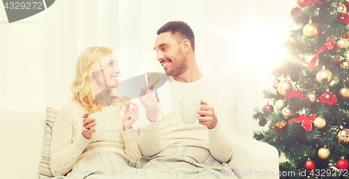 Image of happy couple at home with christmas tree