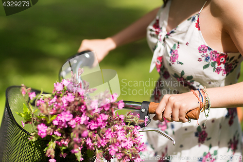 Image of close up of woman riding fixie bicycle outdoors