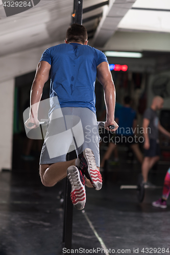 Image of man doing exercises parallel bars