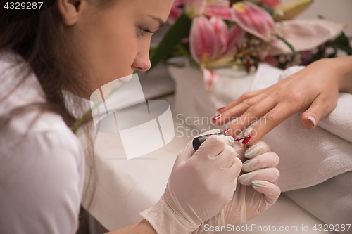 Image of Woman hands receiving a manicure