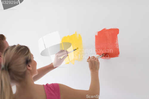 Image of couple painting interior wall