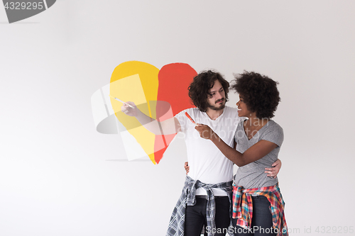 Image of couple with painted heart on wall