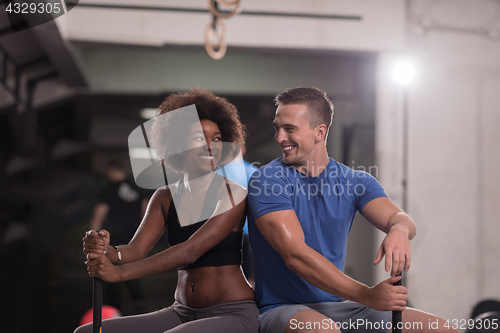 Image of multiethnic couple after workout with hammer