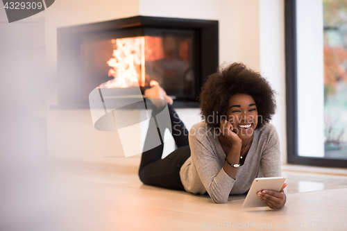 Image of black women using tablet computer on the floor