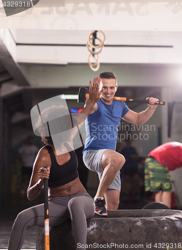 Image of multiethnic couple after workout with hammer