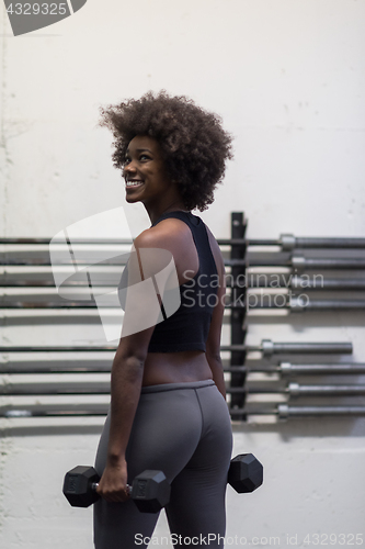 Image of black woman doing bicep curls