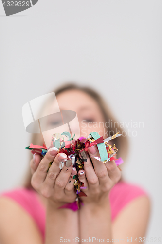 Image of woman blowing confetti in the air