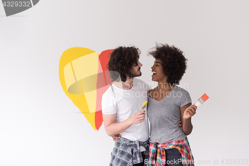 Image of couple with painted heart on wall