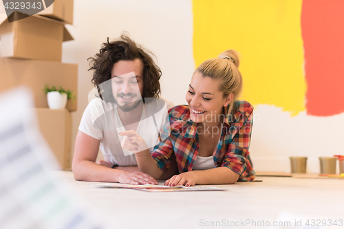 Image of Happy young couple relaxing after painting