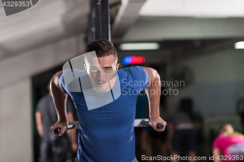 Image of man doing exercises parallel bars