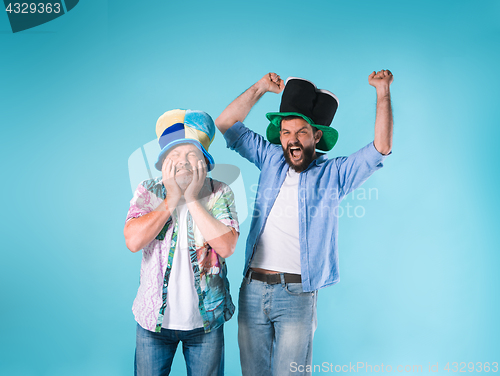 Image of The two football fans over blue