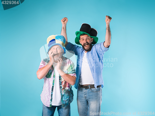 Image of The two football fans over blue
