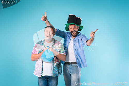 Image of The two football fans over blue