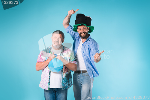 Image of The two football fans over blue