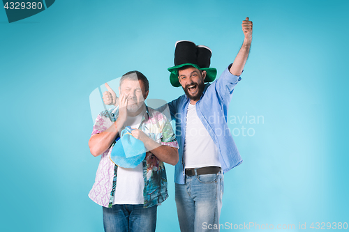 Image of The two football fans over blue