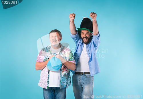 Image of The two football fans over blue