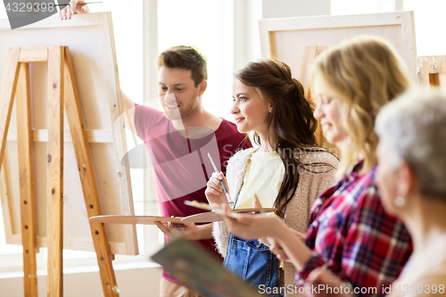 Image of group of young artists painting at art school