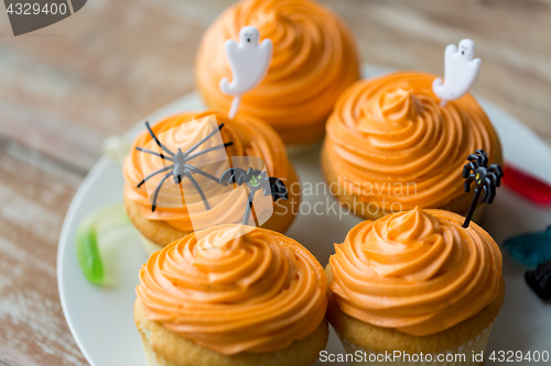 Image of halloween party decorated cupcakes on plate