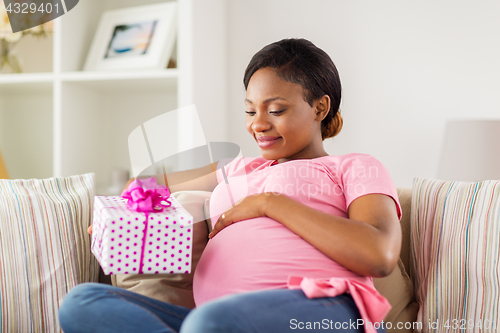 Image of happy african american pregnant woman with gift