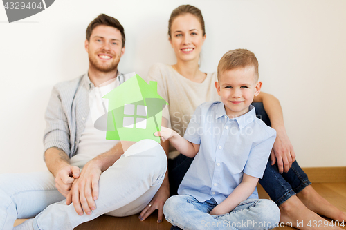 Image of happy family with green house moving to new home