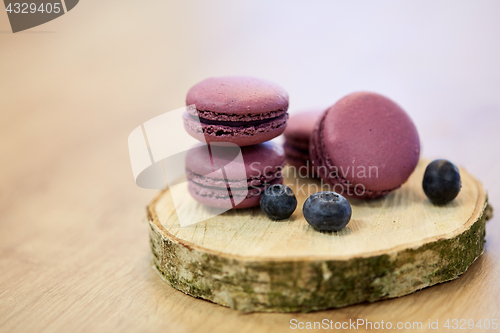 Image of blueberry macarons on wooden stand
