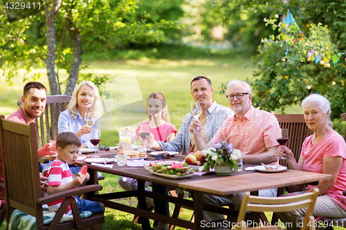 Image of happy family having dinner or summer garden party