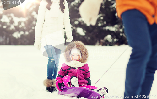 Image of happy family with sled walking in winter forest