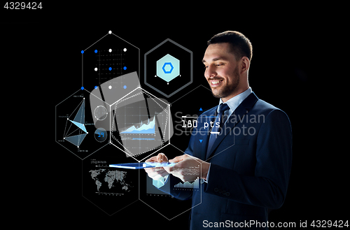 Image of businessman with tablet pc and virtual screen