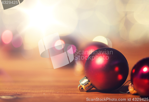 Image of close up of red christmas balls on wood