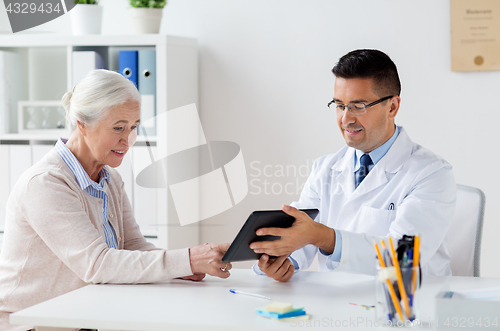 Image of senior woman and doctor with tablet pc at hospital