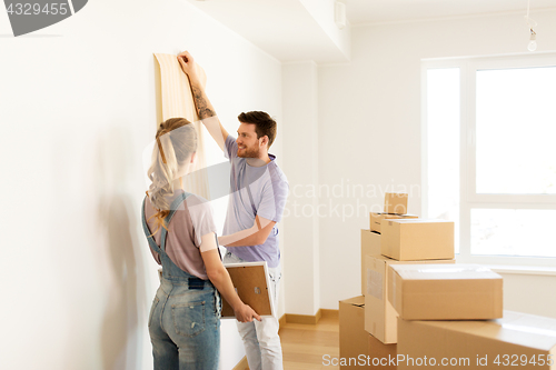 Image of happy couple with boxes moving to new home