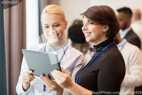 Image of team with tablet pc at business conference