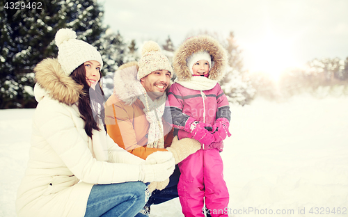 Image of happy family with child in winter clothes outdoors