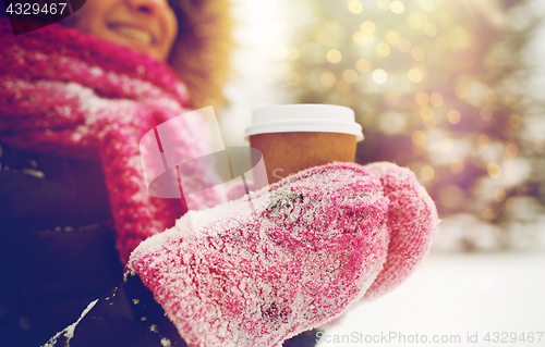 Image of close up of hand with coffee outdoors in winter