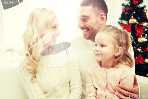 Image of happy family at home with christmas tree