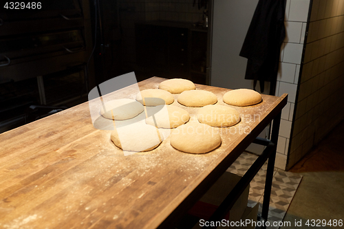 Image of yeast bread dough on bakery kitchen table