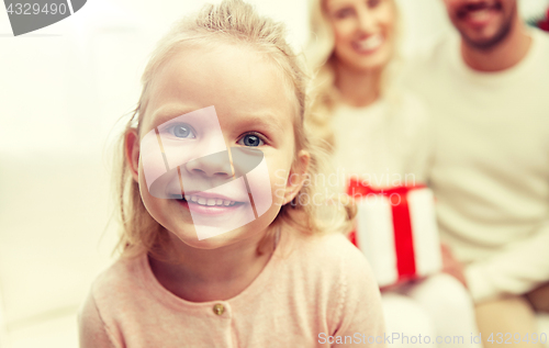 Image of happy family at home with christmas gift box