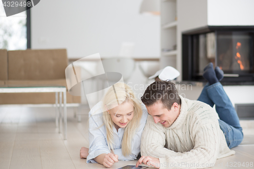 Image of Young Couple using digital tablet on cold winter day