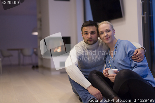 Image of happy couple in front of fireplace