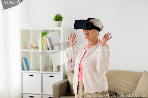 Image of old woman in virtual reality headset or 3d glasses