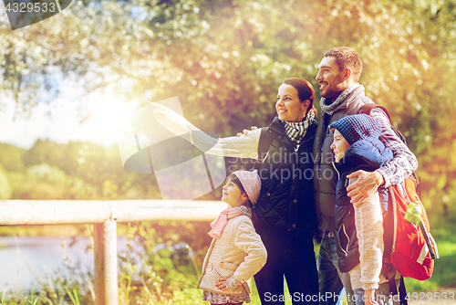 Image of happy family with backpacks hiking