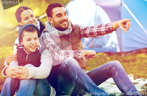 Image of happy family with tent at camp site