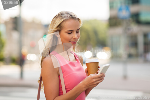 Image of woman with coffee and smartphone in city