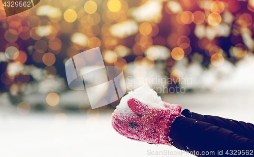 Image of close up of woman holding snow outdoors