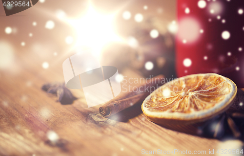 Image of cinnamon, anise and dried orange on wooden board