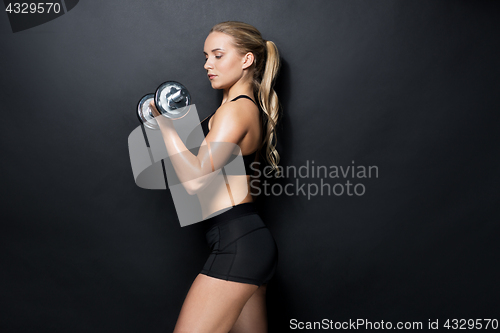 Image of young sporty woman exercising with dumbbell