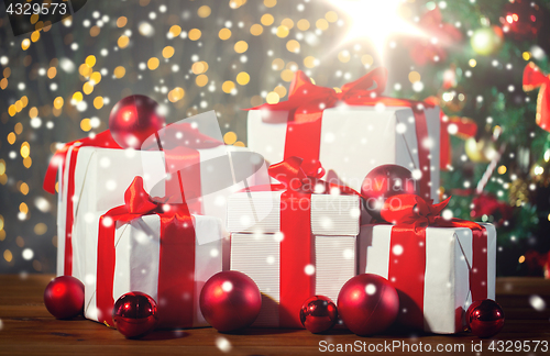 Image of gift boxes and red balls under christmas tree